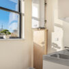 Sun shining through the large window onto the kitchenette