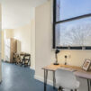 study area with desk leading to open planned living area