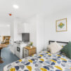 Interior view of the double bed, kitchenette and dining area