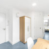 Interior view near the front door showing study area and wardrobe